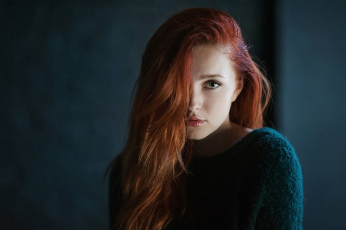 Woman with red hair in a dark sweater