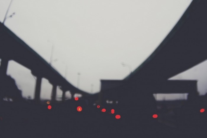Blurred image of highway overpasses and car taillights