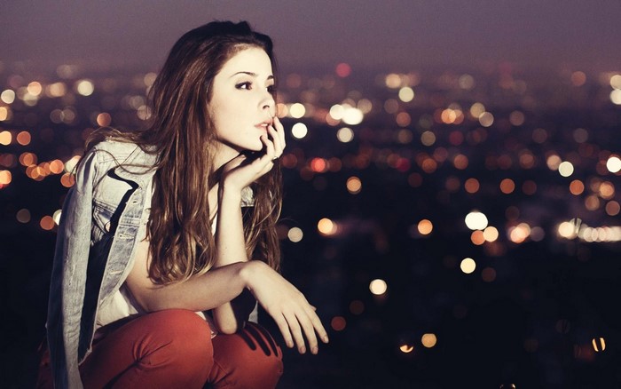 Lena Meyer Landrut posing at night with city lights