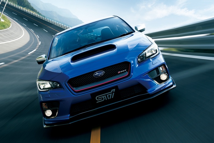 Blue Subaru WRX STI S207 driving on a winding road