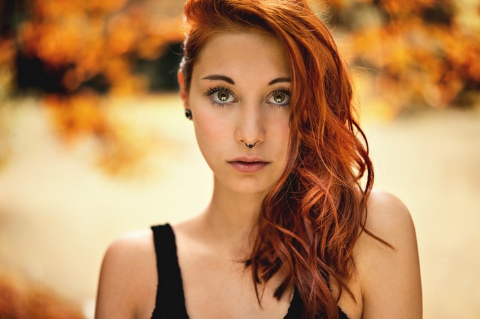 Woman with red hair and nose piercing