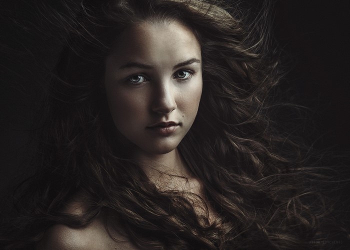 Portrait of a young woman with long brown hair