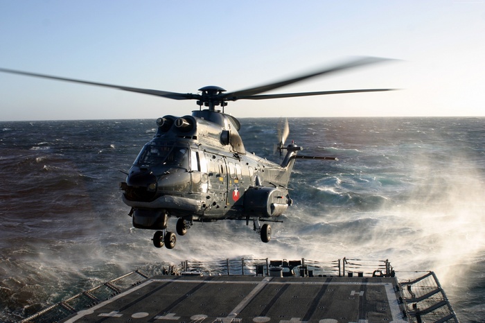 Eurocopter AS332 Super Puma helicopter landing on a ship
