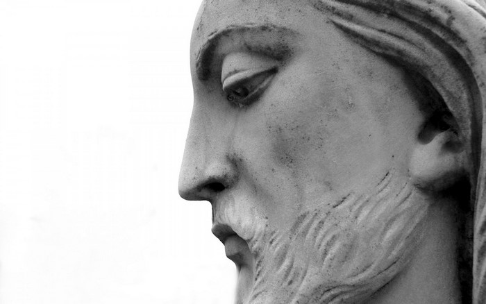 Close-up of Jesus Christ statue's face in black and white