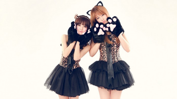 Two women in leopard print costumes with cat ears