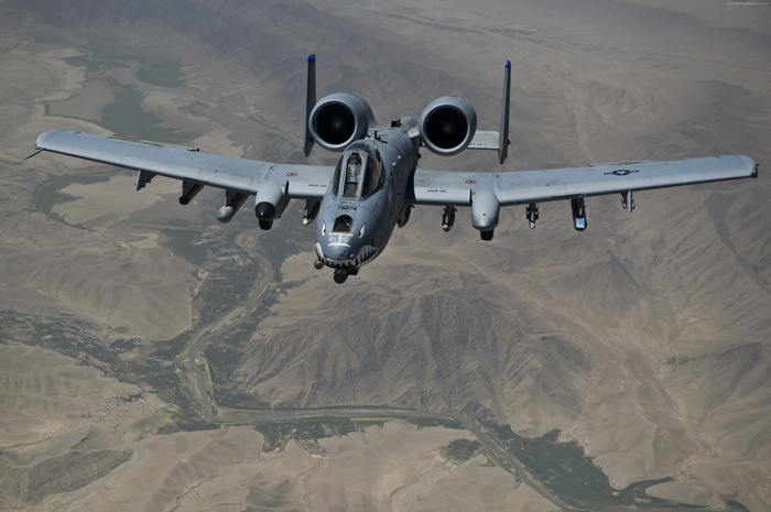 A-10 Thunderbolt II aircraft flying over a valley