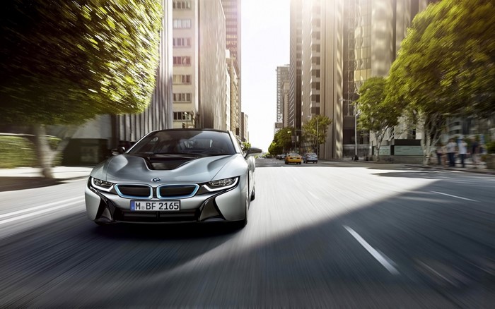 Silver BMW i8 driving on a city street