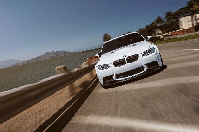 White BMW M3 E92 driving on a coastal road