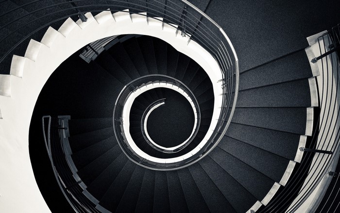 Monochrome spiral staircase with metal railings
