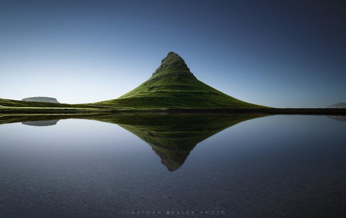 Kirkjufell mountain reflected in water
