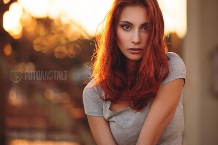 Woman with red hair and nose ring
