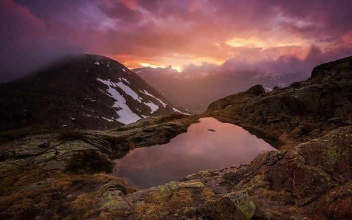Mountain lake at sunset with colorful clouds