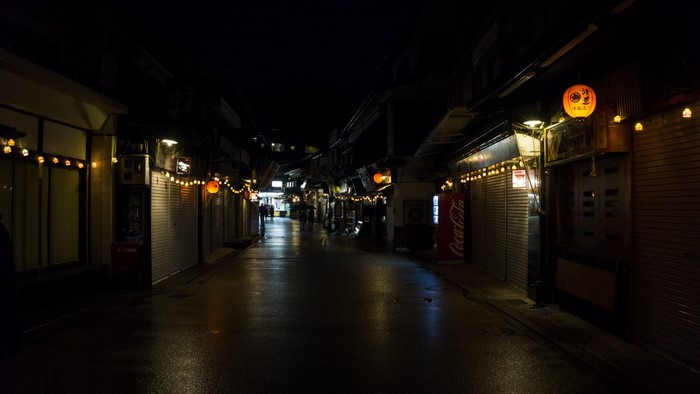 Japanese street at night with lanterns and closed shops