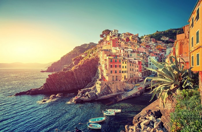 Colorful Italian coastal village at sunset over the sea
