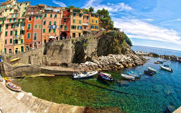 Colorful Italian coastal town with boats in the sea