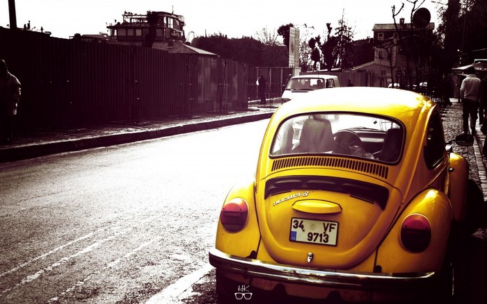 Yellow Volkswagen Beetle parked on a street