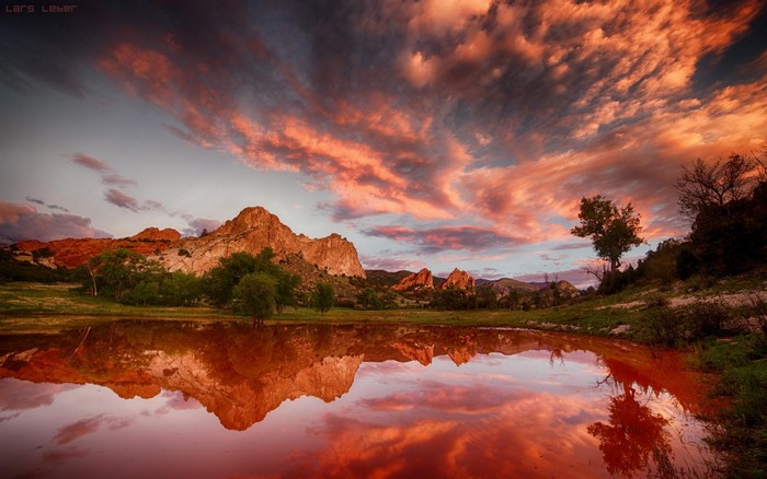 Sunset Reflection Over Tranquil Lake and Hills