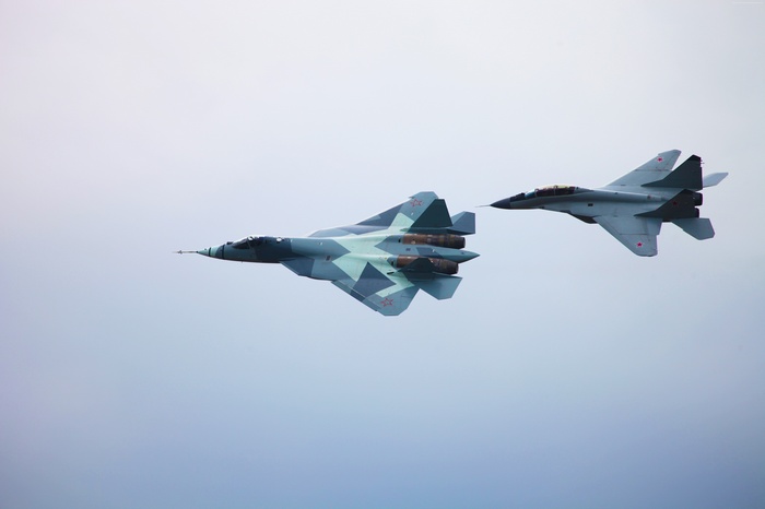 Sukhoi T-50 and MiG-29M2 fighter jets in flight