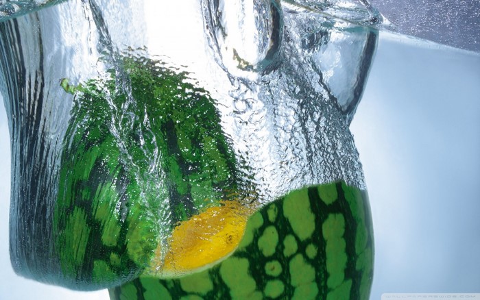 Watermelon splashing into water