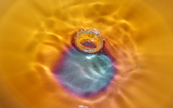 Water splash with colorful ripples