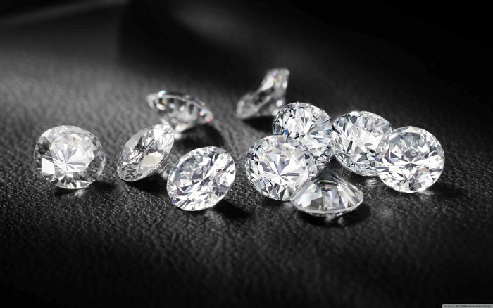 Scattered diamonds on a dark textured surface