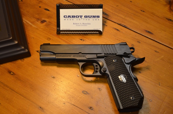 Cabot 1911 pistol with business card