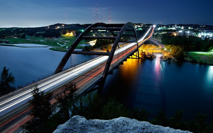 360 Bridge over water at night with light trails