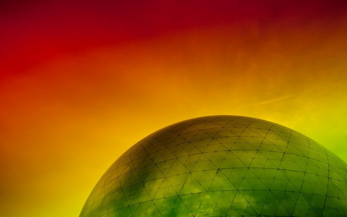 Geodesic dome against a colorful gradient sky