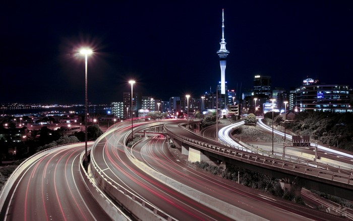 Auckland cityscape at night with Sky Tower and highway