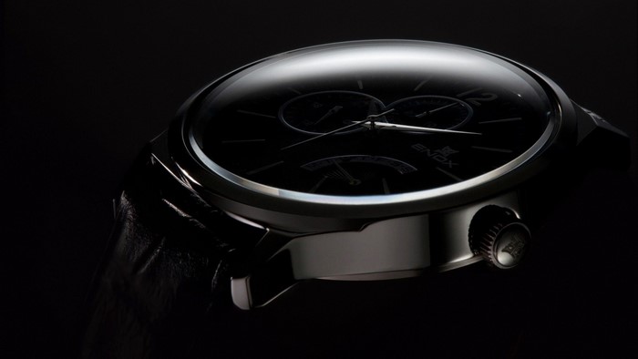 Close-up of a black luxury watch with a dark dial