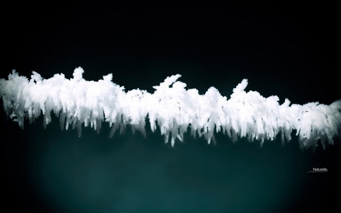 Frost on a wire against a dark background