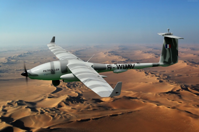 Sagem Patroller drone flying over desert dunes