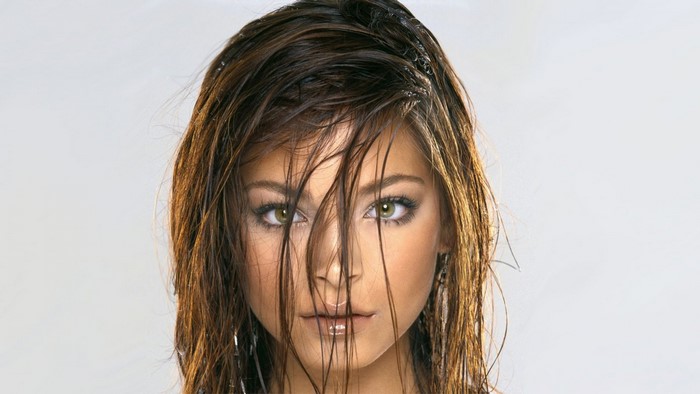 Kristin Kreuk with wet brown hair covering her face