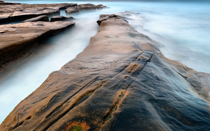 Rocky coastline with misty ocean waves