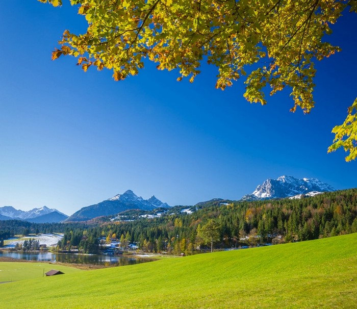 Autumn landscape with mountains, lake, and trees