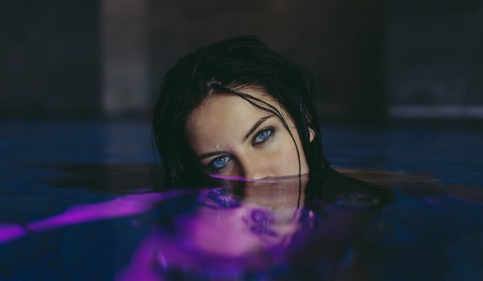 Woman with blue eyes in water