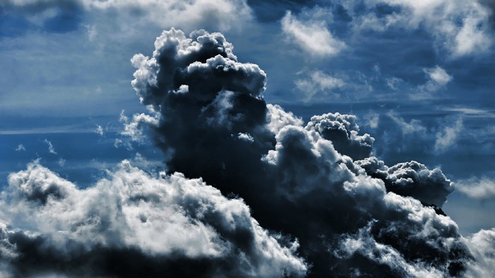 Dark storm clouds in a blue sky