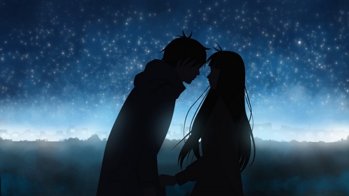 Couple silhouetted against a starry sky