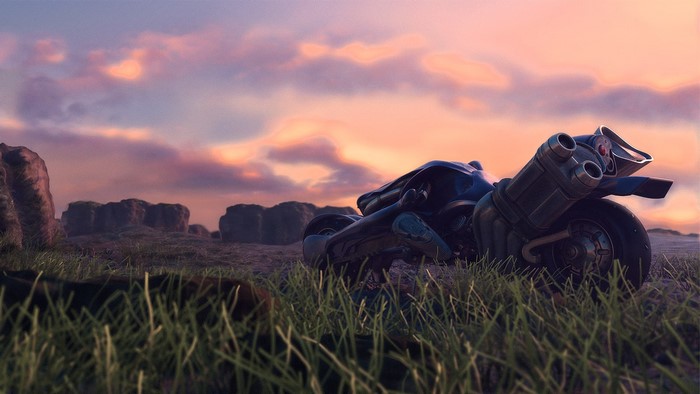 Motorcycle in a grassy landscape at sunset