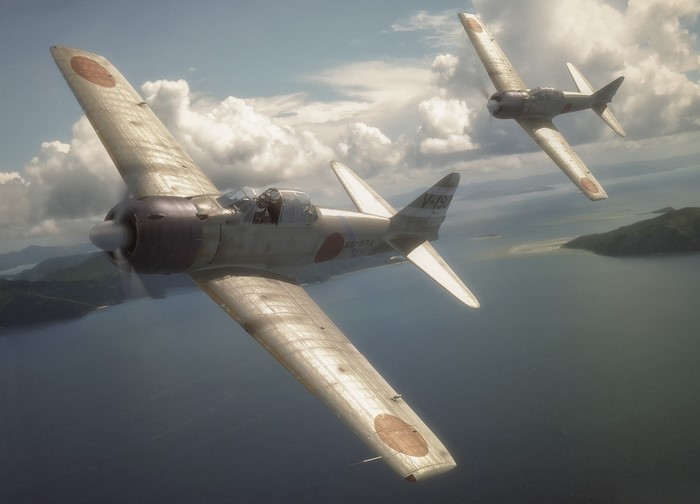 Two Japanese Zero fighter planes flying over water