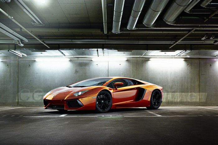 Orange Lamborghini Aventador parked in a garage