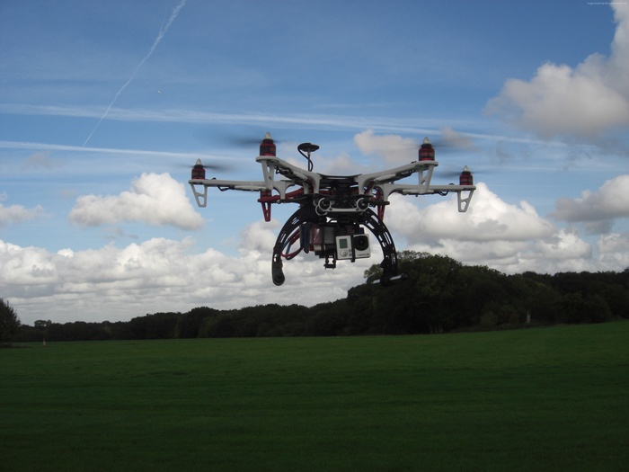 DJI FlameWheel F550 drone flying over a field