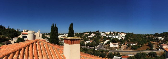 Panoramic view of a Portuguese town with tiled roofs and cypress trees