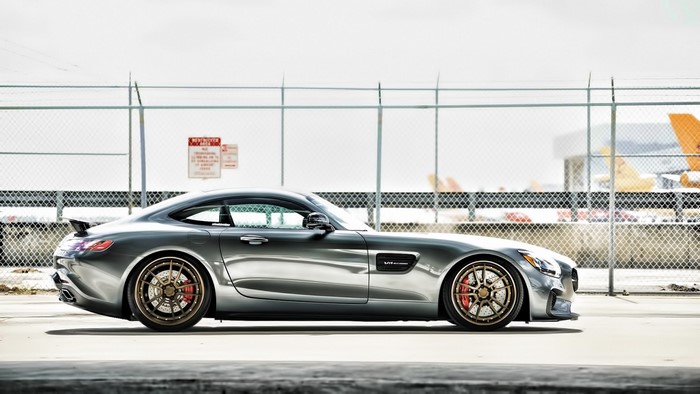 Mercedes-Benz AMG GT sports car parked near fence
