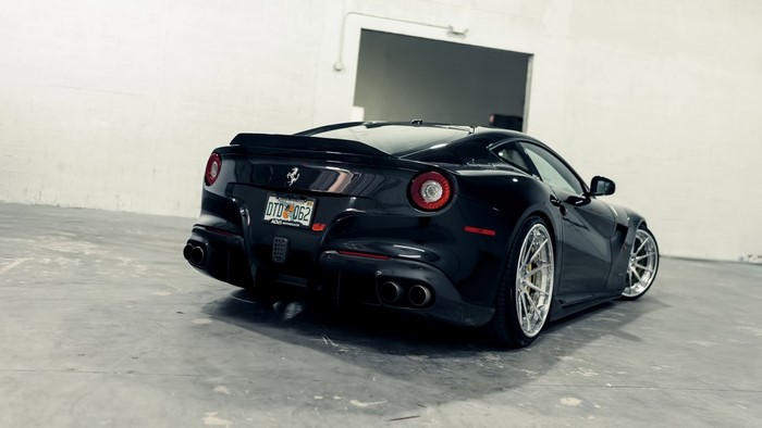 Black Ferrari F12berlinetta parked in a garage