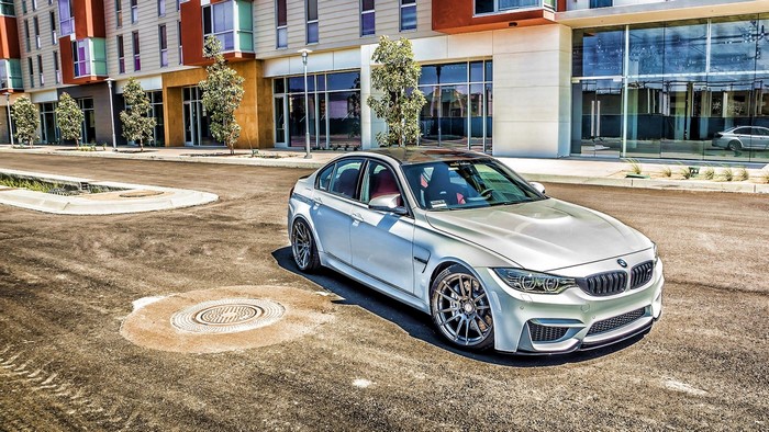 Silver BMW M3 Sedan parked on asphalt street