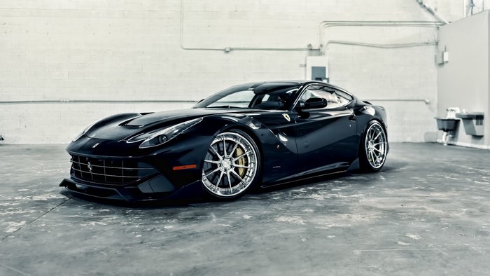 Black Ferrari F12 Berlinetta parked in a garage