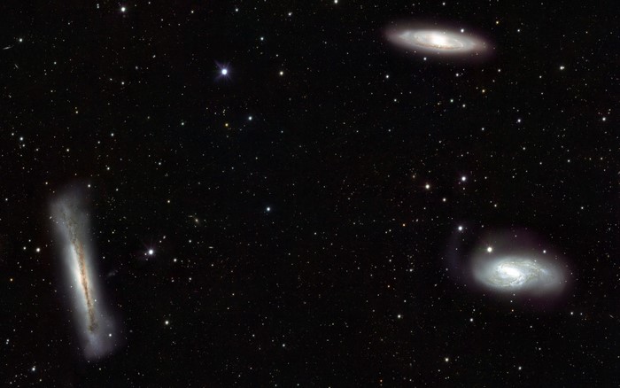 Three galaxies and stars in deep space