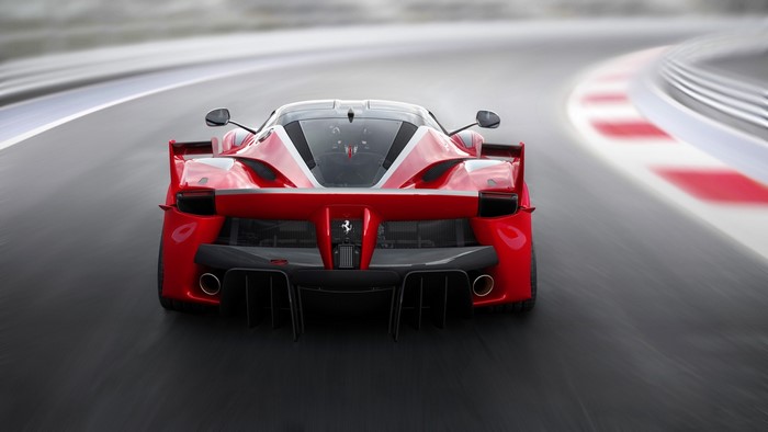 Red Ferrari FXX K driving on a race track