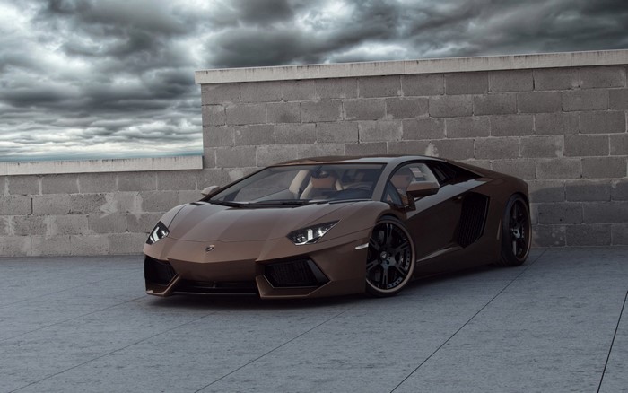 Brown Lamborghini Aventador parked near a brick wall